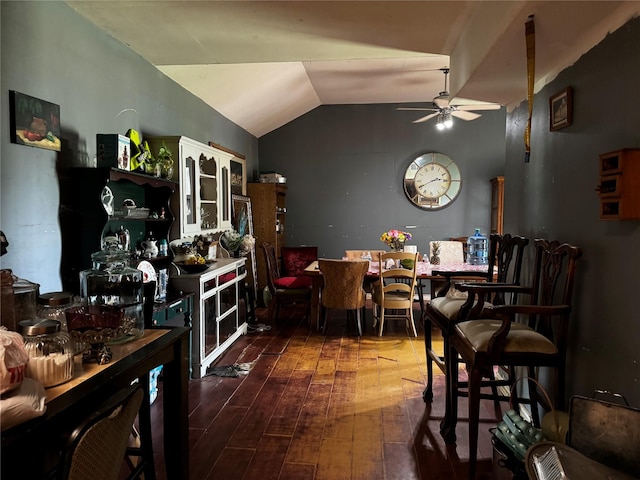 dining room with vaulted ceiling, ceiling fan, and wood-type flooring