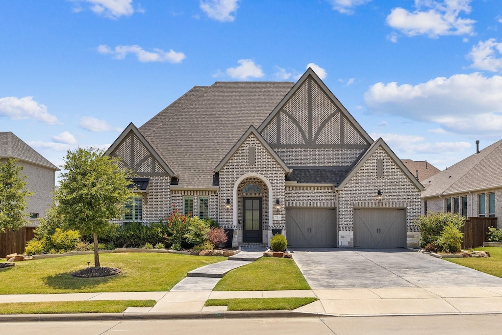 view of front of property with a front yard and a garage