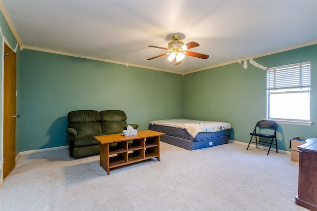 carpeted bedroom with ornamental molding and ceiling fan