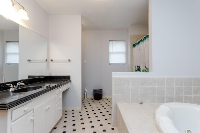 bathroom featuring shower with separate bathtub and vanity