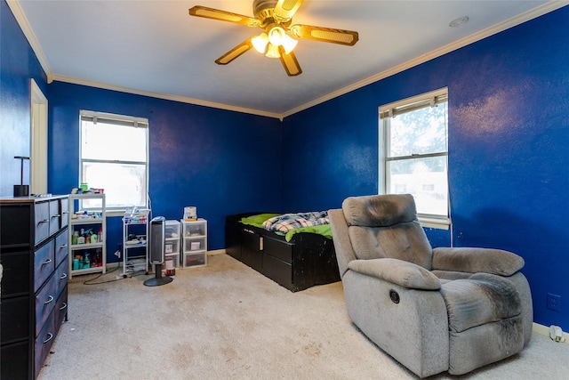 carpeted bedroom featuring ceiling fan and ornamental molding