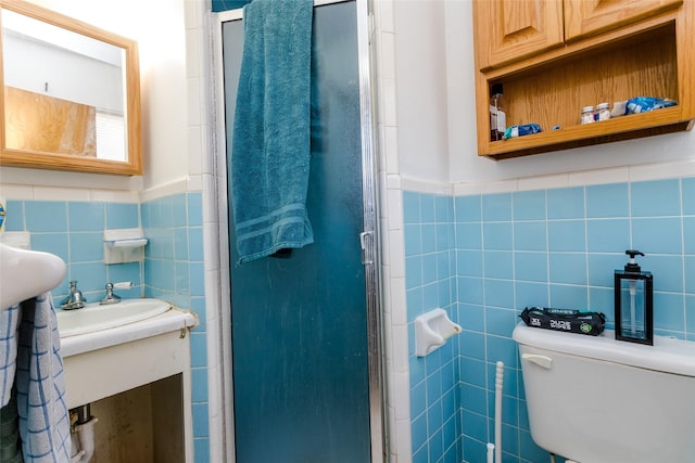 bathroom featuring tile walls, toilet, and walk in shower