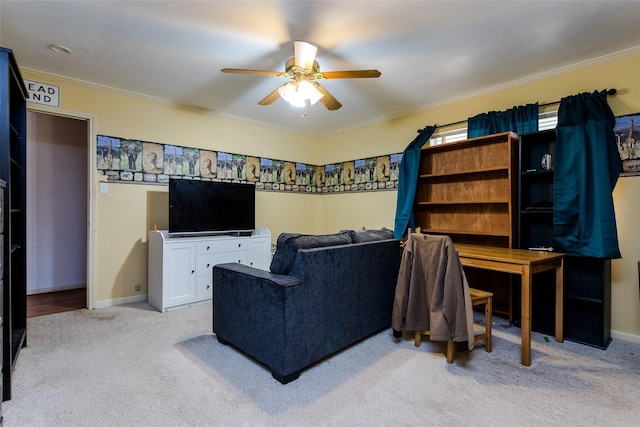 living room with ceiling fan, crown molding, and light carpet