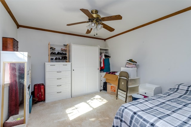 bedroom featuring ceiling fan, light carpet, a closet, and crown molding