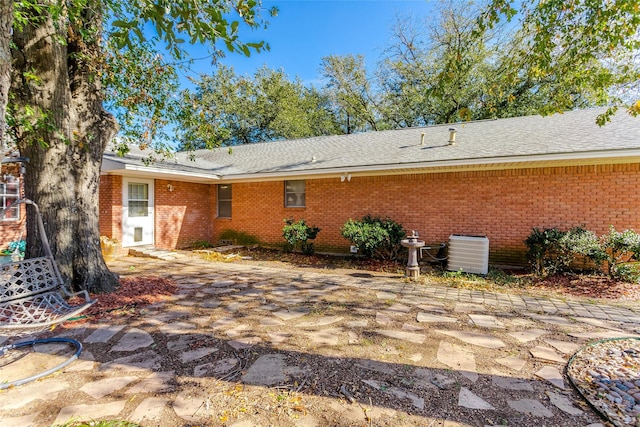 back of property featuring central AC