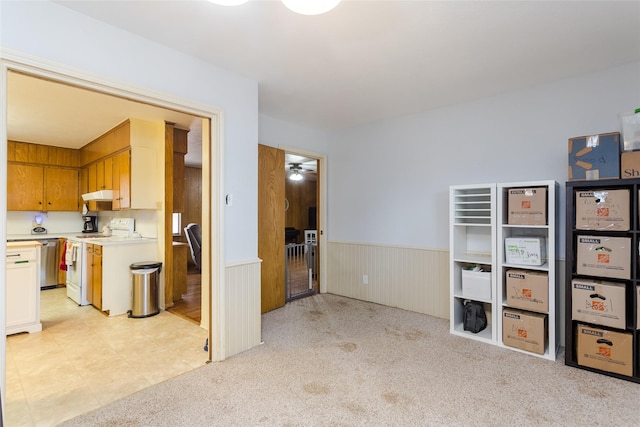 kitchen with ceiling fan, white electric range, stainless steel dishwasher, and light carpet