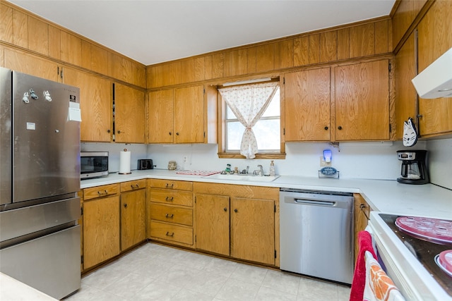 kitchen with appliances with stainless steel finishes, extractor fan, and sink