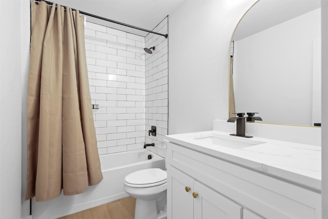 full bathroom featuring toilet, shower / bathtub combination with curtain, hardwood / wood-style floors, and vanity