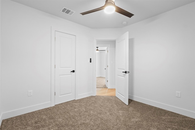 unfurnished bedroom with ceiling fan and light colored carpet