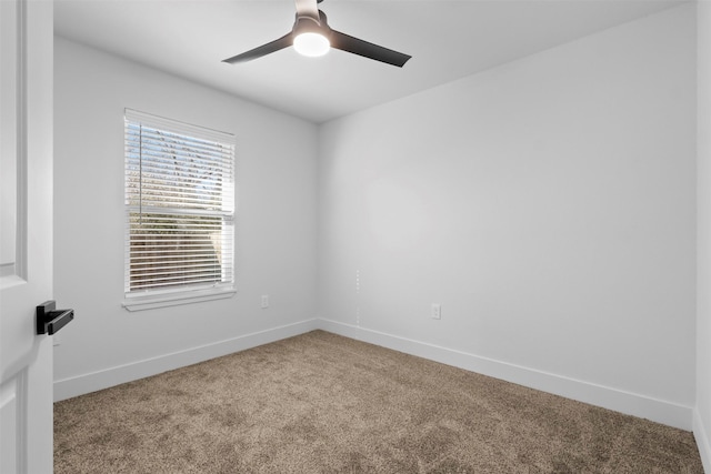 unfurnished room with ceiling fan and carpet