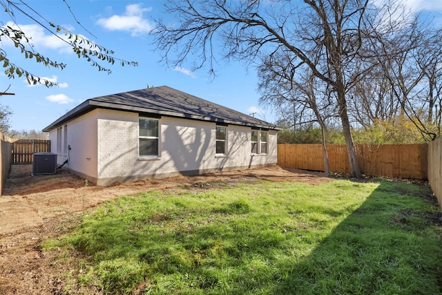 rear view of property featuring a yard