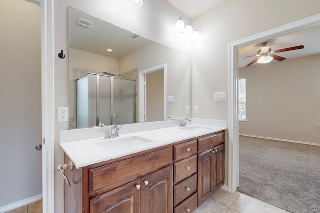 bathroom featuring ceiling fan, vanity, a shower with shower door, and tile patterned flooring