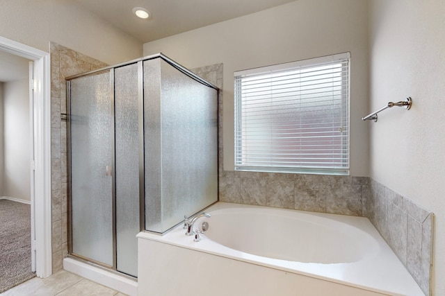 bathroom featuring tile patterned flooring and separate shower and tub