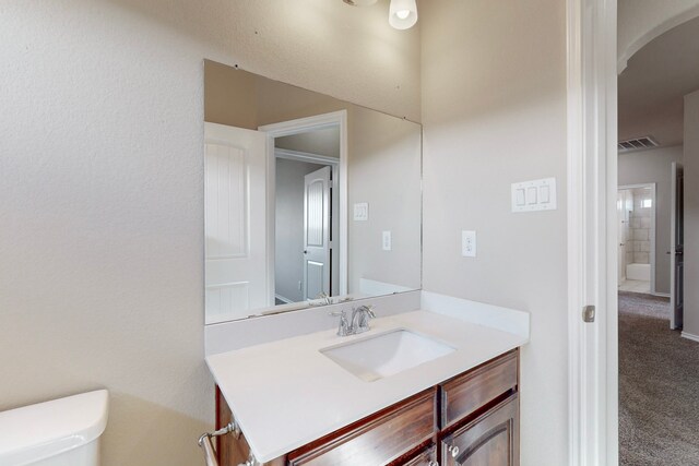 bathroom featuring vanity and toilet