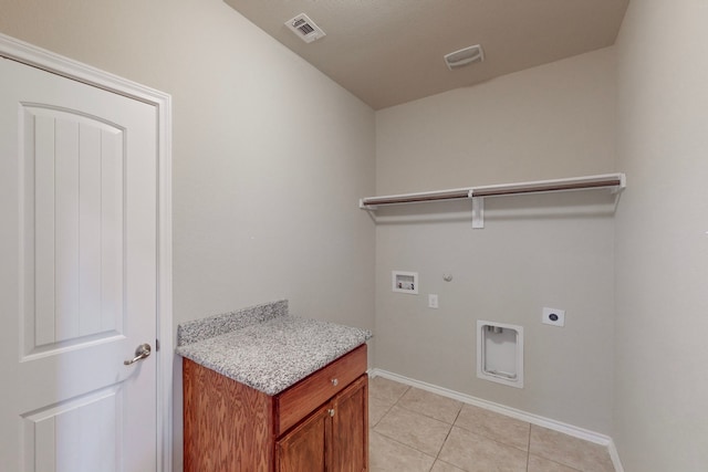 clothes washing area with washer hookup, hookup for a gas dryer, light tile patterned floors, and electric dryer hookup