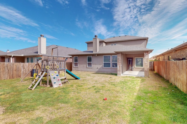 rear view of house featuring a playground and a lawn