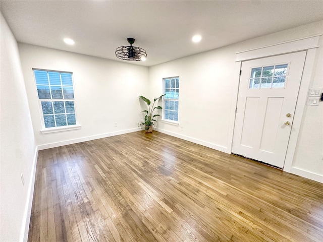 foyer entrance with a notable chandelier and hardwood / wood-style floors