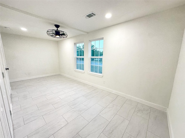 empty room featuring a chandelier