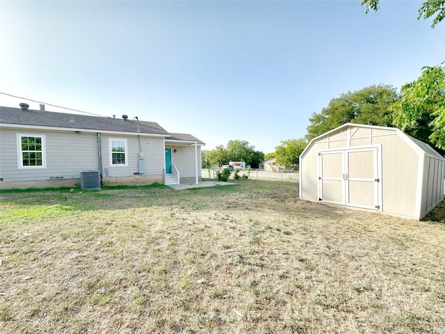 view of yard with central AC and a shed