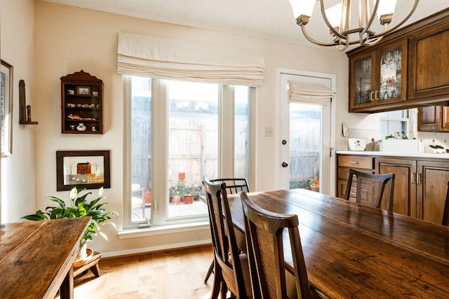 dining room featuring light hardwood / wood-style flooring and an inviting chandelier