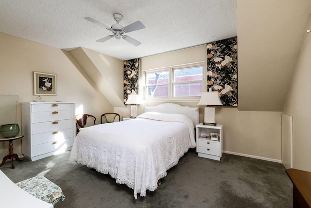 bedroom with a textured ceiling, dark colored carpet, and ceiling fan