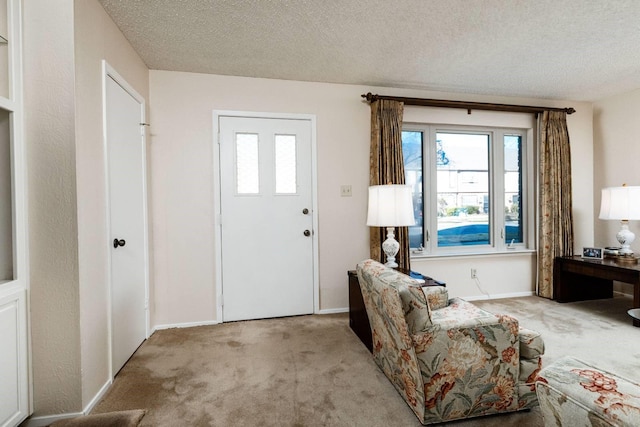 entryway featuring a textured ceiling and light carpet