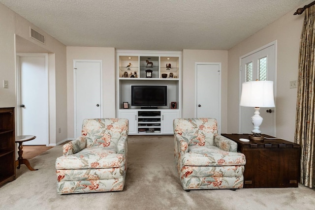 living room with a textured ceiling and carpet