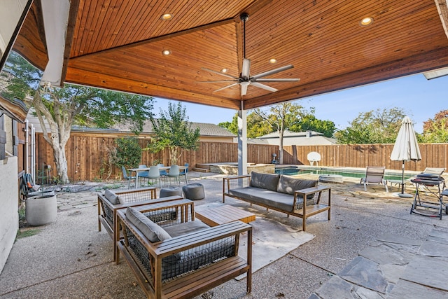 view of patio / terrace featuring ceiling fan, a fenced in pool, and outdoor lounge area