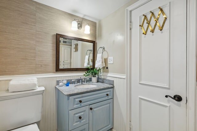 bathroom featuring toilet and vanity