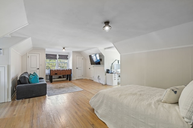 bedroom with lofted ceiling and light wood-type flooring