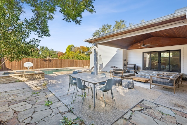 view of patio / terrace featuring a pool with hot tub, grilling area, ceiling fan, and an outdoor living space