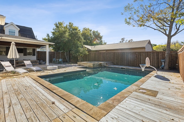 view of pool featuring a deck and an in ground hot tub