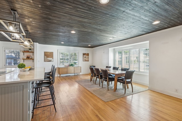 dining space with wooden ceiling, light wood-type flooring, and crown molding