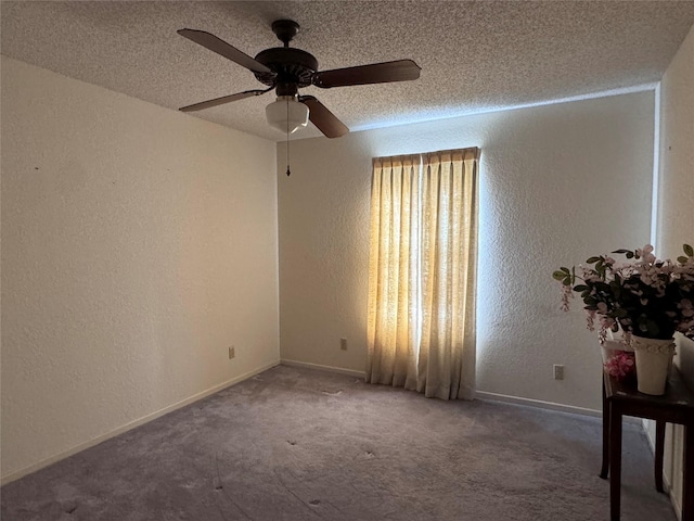 unfurnished room featuring a textured ceiling, ceiling fan, and dark carpet