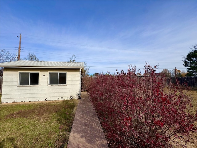 view of property exterior featuring a lawn