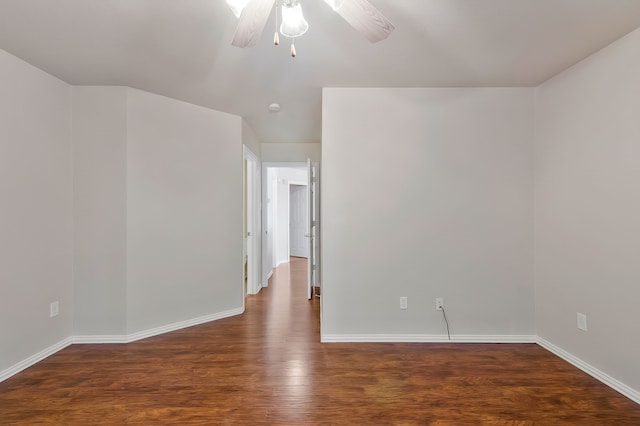 empty room featuring dark wood-type flooring and ceiling fan