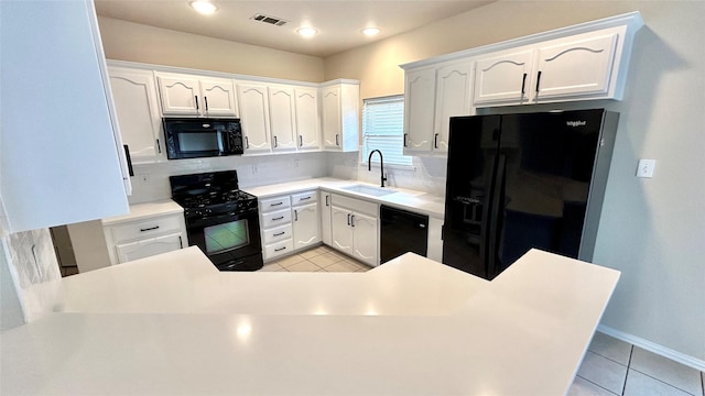 kitchen featuring black appliances, white cabinets, sink, and light tile patterned floors