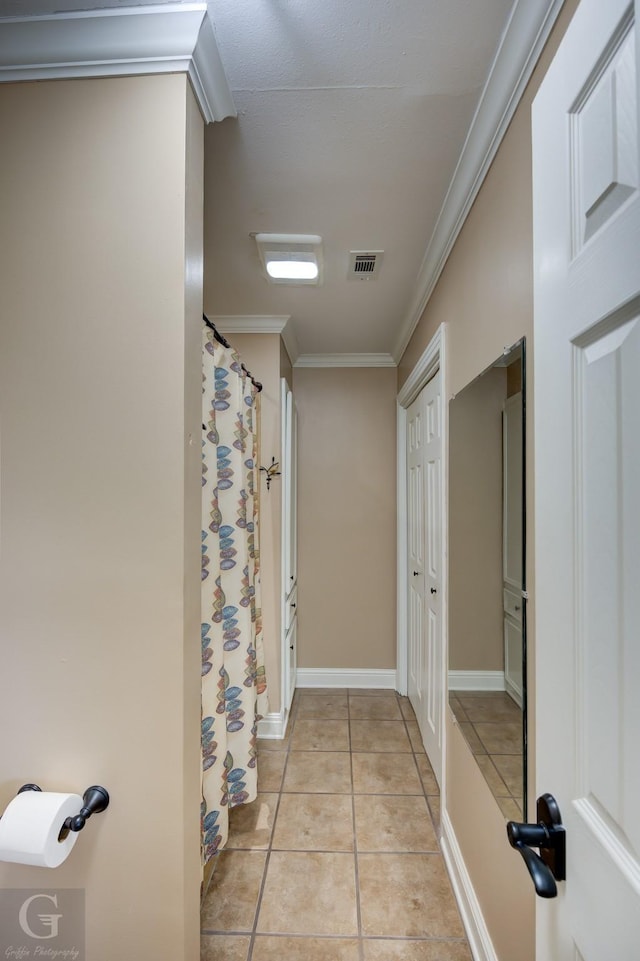 bathroom with ornamental molding and tile patterned floors