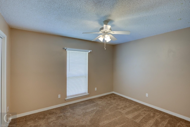 unfurnished room with a textured ceiling, ceiling fan, and carpet