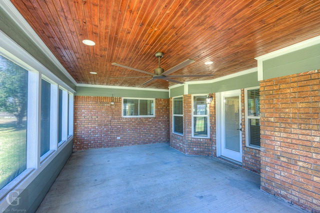 unfurnished sunroom with ceiling fan