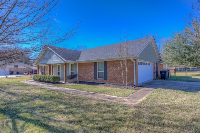 single story home with a porch, a front yard, and a garage