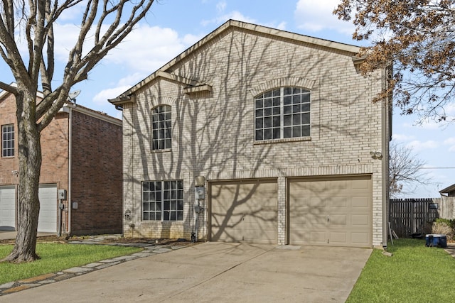 traditional home with a garage, fence, brick siding, and driveway