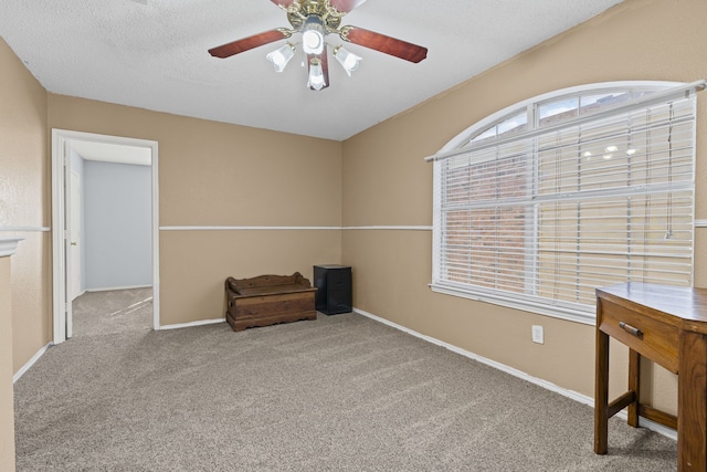 unfurnished room with baseboards, a textured ceiling, ceiling fan, and carpet flooring