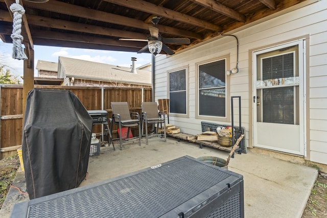 view of patio / terrace with ceiling fan and fence