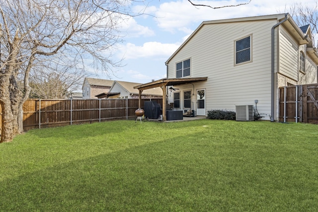 rear view of house with a patio, central AC unit, a fenced backyard, and a lawn