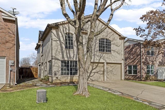 view of front of property with a front lawn, fence, concrete driveway, an attached garage, and brick siding