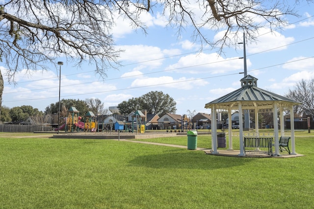 view of property's community featuring a gazebo, a lawn, and playground community