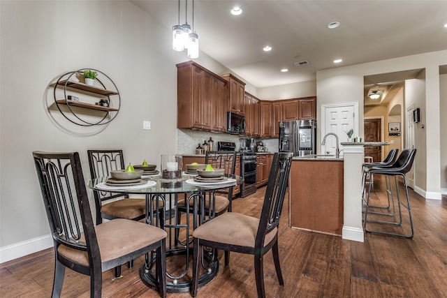 dining area featuring sink and dark hardwood / wood-style floors