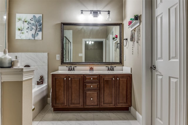 bathroom featuring a tub to relax in and vanity