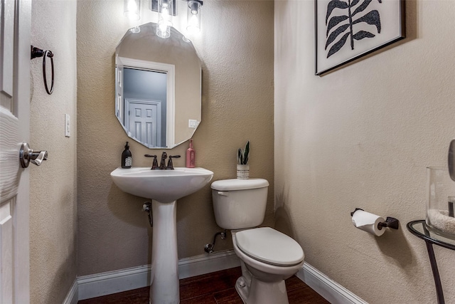 bathroom with wood-type flooring and toilet